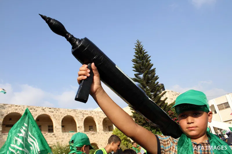 A Palestinian boy holds a mock rocket during a rally showing their support and solidarity with Hamas in the West Bank city of Tulkarem, 30 August 2014. An indefinite ceasefire to end seven weeks of fighting between Israe...