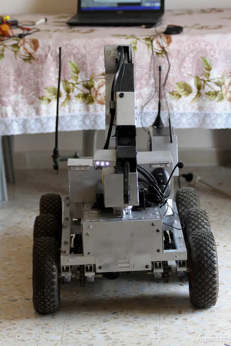 Khalil Awawdeh, a Palestinian inventor displays a military tank that he makes it by a cartoon in the West Bank city of Hebron on August 31, 2014. The 22-year-old man invents explosives detection device and he uses a cart...