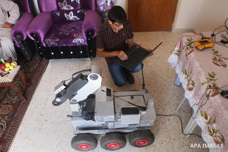 Khalil Awawdeh, a Palestinian inventor who works at his room in the West Bank city of Hebron on August 31, 2014. The 22-year-old man invents explosives detection device and he uses a cartoon to makes military tanks. Phot...