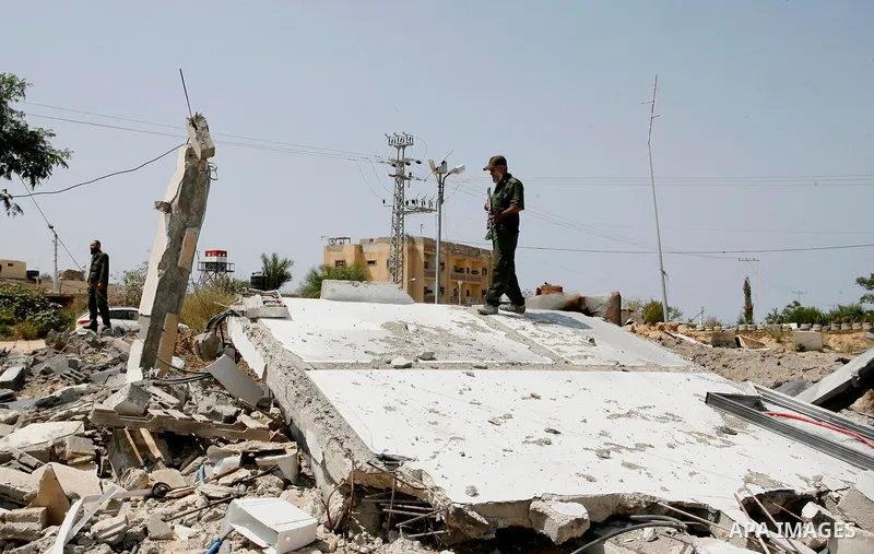 Palestinian security forces inspect security headquarters destroyed during fighting between Hamas militants and Israel on the border between Egypt and Gaza in Rafah, southern Gaza Strip in August 31, 2014. An indefinite...