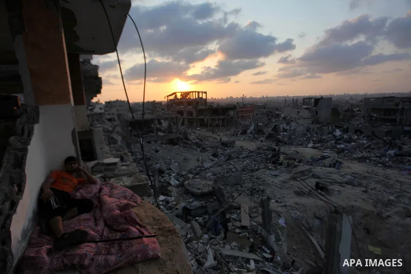A Palestinian man lies down among a destroyed house after returning home in the Tufah neighbourhood in eastern Gaza City on August 31, 2014. Calm returned to the coastal enclave in a August 26 ceasefire, and Gazans were...