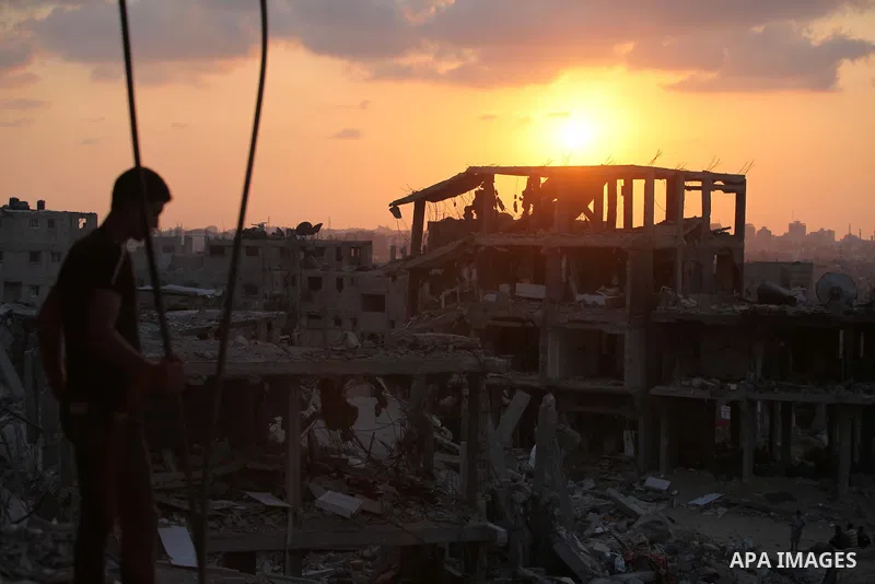 A Palestinian man sits on the rubble of destroyed houses after returning home in the Tufah neighbourhood in eastern Gaza City on August 31, 2014. Calm returned to the coastal enclave in a August 26 ceasefire, and Gazans...