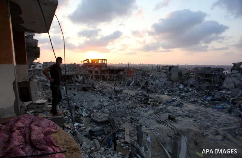 A Palestinian man sits on the rubble of destroyed houses after returning home in the Tufah neighbourhood in eastern Gaza City on August 31, 2014. Calm returned to the coastal enclave in a August 26 ceasefire, and Gazans...