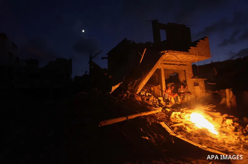 Palestinians sit on the rubble of their destroyed house after returning home in the Tufah neighbourhood in eastern Gaza City on August 31, 2014. Calm returned to the coastal enclave in a August 26 ceasefire, and Gazans w...