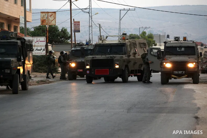 Israeli soldiers patrol the streets during a military operation at al-Faraa refugee camp near the West Bank City of Jenin on Sep. 01, 2014. Israeli soldiers raided many houses and detained 7 Palestinians. Photo by Nedal...