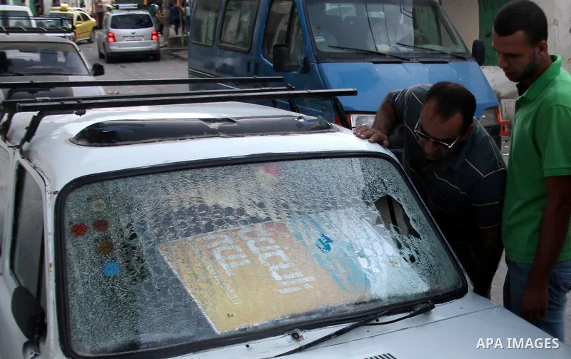 Palestinians inspect their damage car after a military operation at al-Faraa refugee camp near the West Bank City of Jenin Sep. 01, 2014. Israeli soldiers raided many houses and detained 7 Palestinians. Photo by Nedal Es...