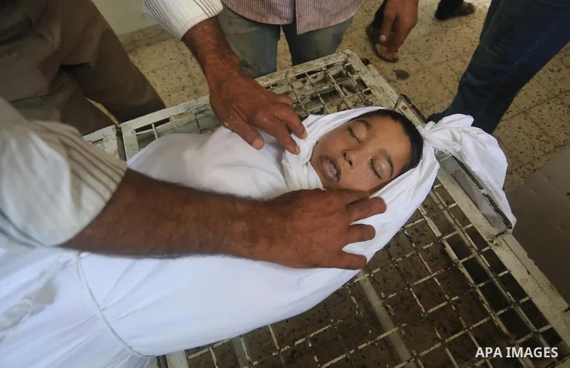Palestinians mourn next to the body of Ziad El-refi, who witnesses said was killed in an Israeli air strike, during his funeral at Al-shifa hospital, in Gaza city, on Sep. 01, 2014. El-refi dead on Monday, affected by fr...