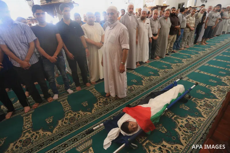 Palestinians pray on the body of Ziad El-refi, who witnesses said was killed in an Israeli air strike, during his funeral Al-shifa hospital, in Gaza city, on Sep. 01, 2014. El-refi dead on Monday, affected by from seriou...