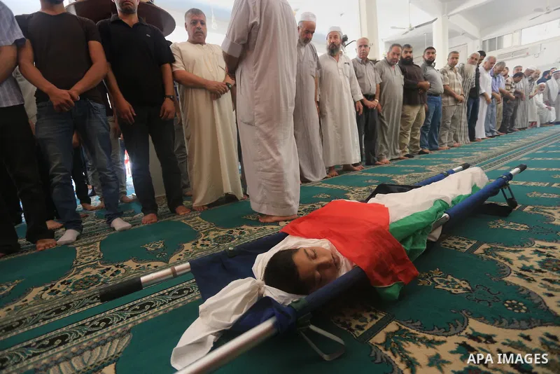 Palestinians pray on the body of Ziad El-refi, who witnesses said was killed in an Israeli air strike, during his funeral Al-shifa hospital, in Gaza city, on Sep. 01, 2014. El-refi dead on Monday, affected by from seriou...
