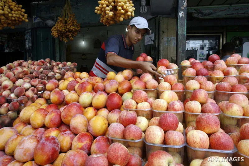 A Palestinian vendor sells fruits at his shop in Rafah in the southern Gaza Strip, o n Sep. 01, 2014. Calm returned to the coastal enclave in a August 26 ceasefire, and Gazans were gradually starting to rebuild their liv...