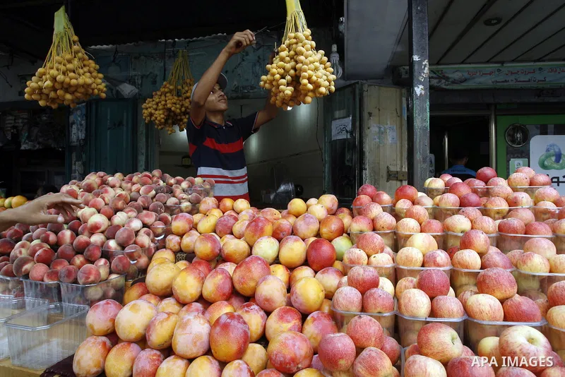 A Palestinian vendor sells fruits at his shop in Rafah in the southern Gaza Strip, o n Sep. 01, 2014. Calm returned to the coastal enclave in a August 26 ceasefire, and Gazans were gradually starting to rebuild their liv...