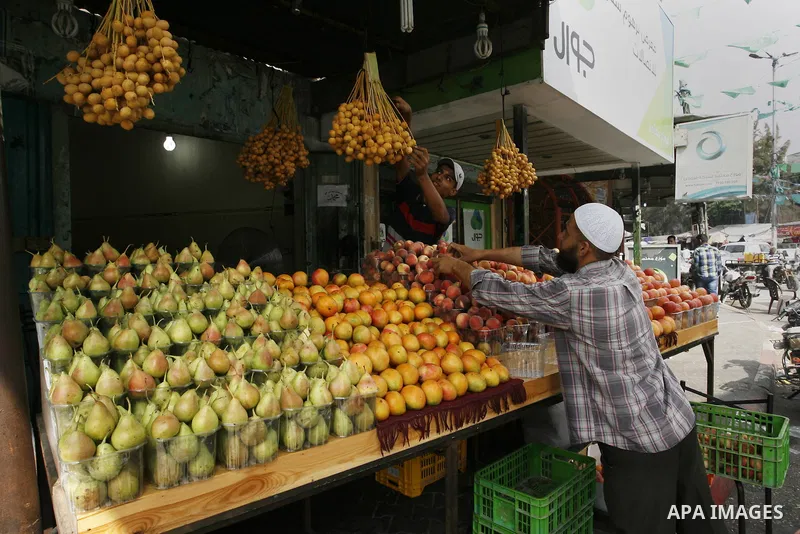 A Palestinian vendor sells fruits at his shop in Rafah in the southern Gaza Strip, o n Sep. 01, 2014. Calm returned to the coastal enclave in a August 26 ceasefire, and Gazans were gradually starting to rebuild their liv...