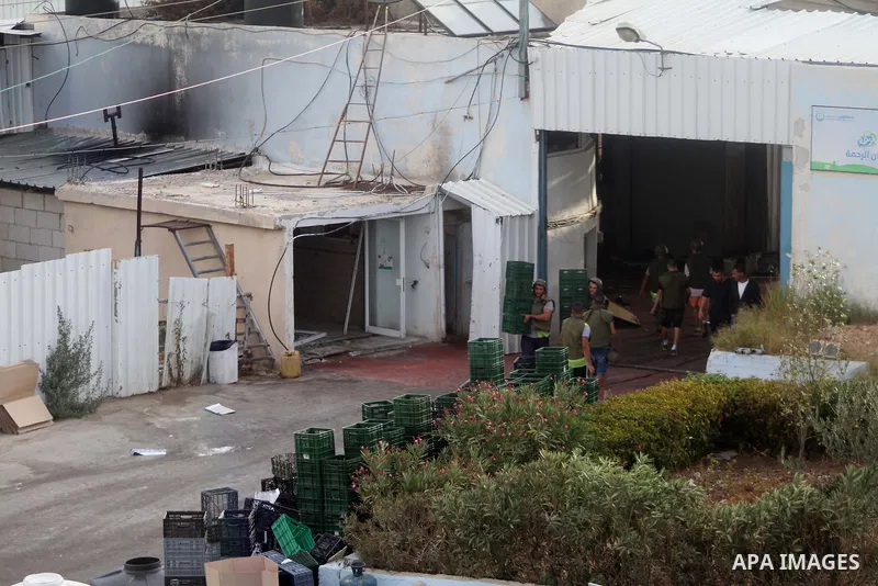 Palestinians inspect the rubble of a dairy factory demolished by Israeli bulldozers, at the al-Rama neighborhood near the West Bank city of Hebron on September 2, 2014. Israeli bulldozers demolished a dairy factory in He...