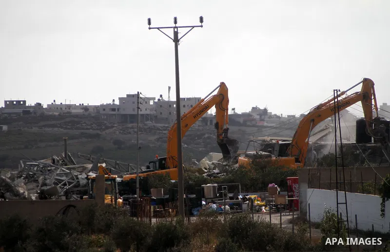 Israeli bulldozers demolish a dairy factory, at the al-Rama neighborhood near the West Bank city of Hebron on September 2, 2014. Israeli bulldozers demolished a dairy factory in Hebron and Bedouin homes east of Jerusalem...