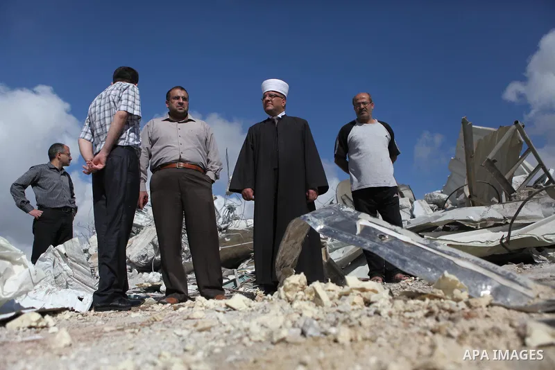 Palestinians inspect the rubble of a dairy factory demolished by Israeli bulldozers, at the al-Rama neighborhood near the West Bank city of Hebron on September 2, 2014. Israeli bulldozers demolished a dairy factory in He...