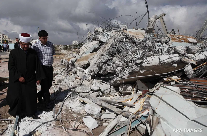 Palestinians inspect the rubble of a dairy factory demolished by Israeli bulldozers, at the al-Rama neighborhood near the West Bank city of Hebron on September 2, 2014. Israeli bulldozers demolished a dairy factory in He...