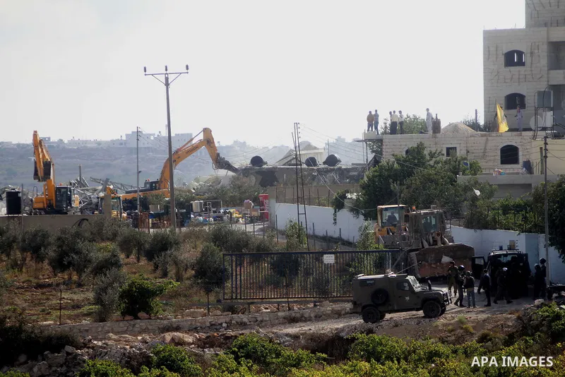 Israeli bulldozers demolish a dairy factory, at the al-Rama neighborhood near the West Bank city of Hebron on September 2, 2014. Israeli bulldozers demolished a dairy factory in Hebron and Bedouin homes east of Jerusalem...