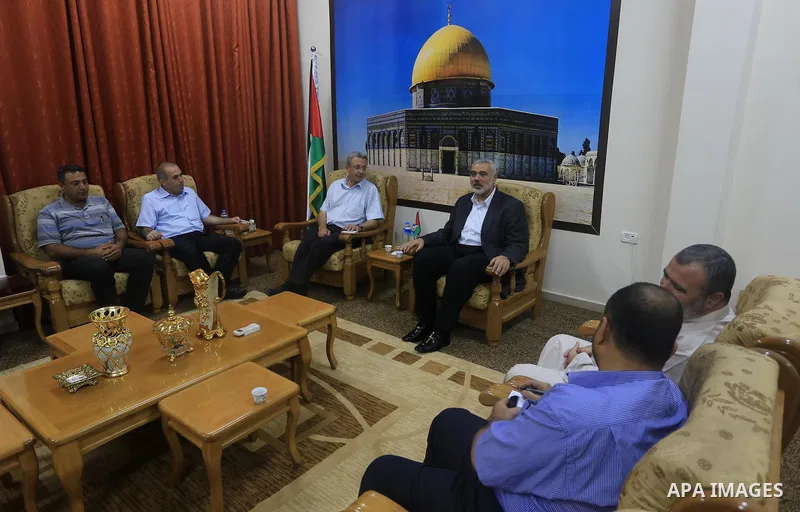 Palestinian top Hamas leader in Gaza, Ismail Haniyeh meets with Palestinian legislator Mustafa Barghouti, in Gaza City September 2, 2014. Photo by Mohammed Asad