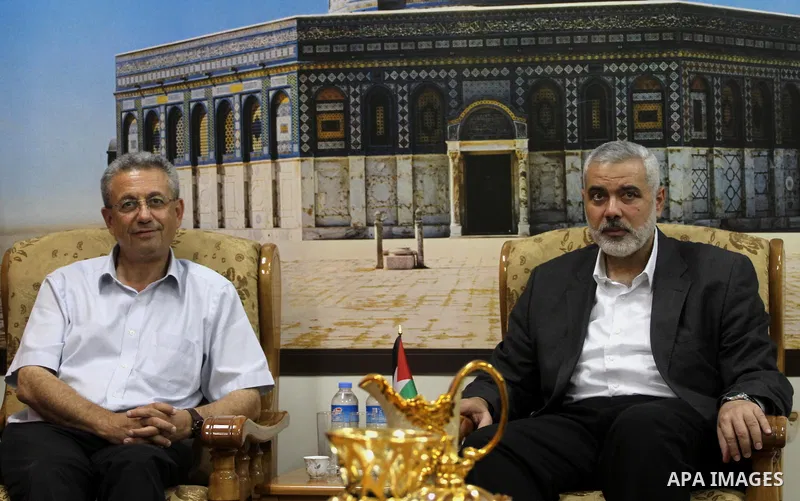 Palestinian top Hamas leader in Gaza, Ismail Haniyeh meets with Palestinian legislator Mustafa Barghouti, in Gaza City September 2, 2014. Photo by Mohammed Asad