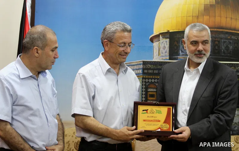 Palestinian top Hamas leader in Gaza, Ismail Haniyeh meets with Palestinian legislator Mustafa Barghouti, in Gaza City September 2, 2014. Photo by Mohammed Asad