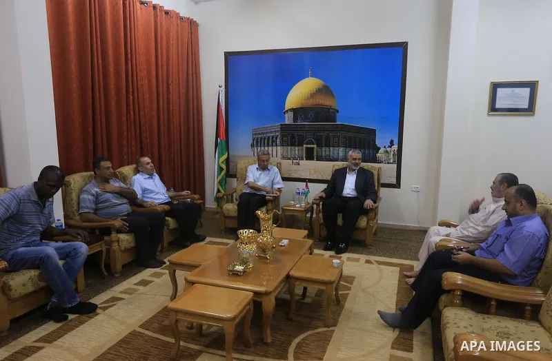 Palestinian top Hamas leader in Gaza, Ismail Haniyeh meets with Palestinian legislator Mustafa Barghouti, in Gaza City September 2, 2014. Photo by Mohammed Asad