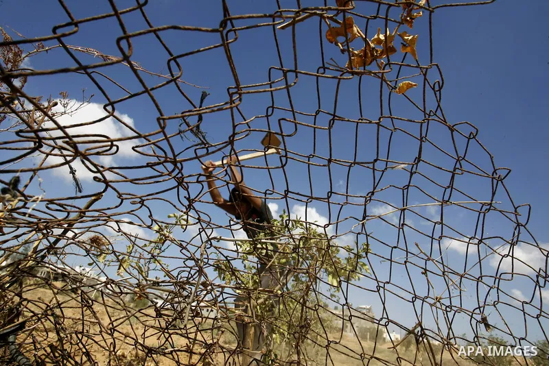 A Palestinian boy inspects his family's farmland which destroyed during fighting between Hamas militants and Israel near the Israeli Gaza border fence in east of Khan Younis, southern Gaza Strip September 2, 2014. An ope...