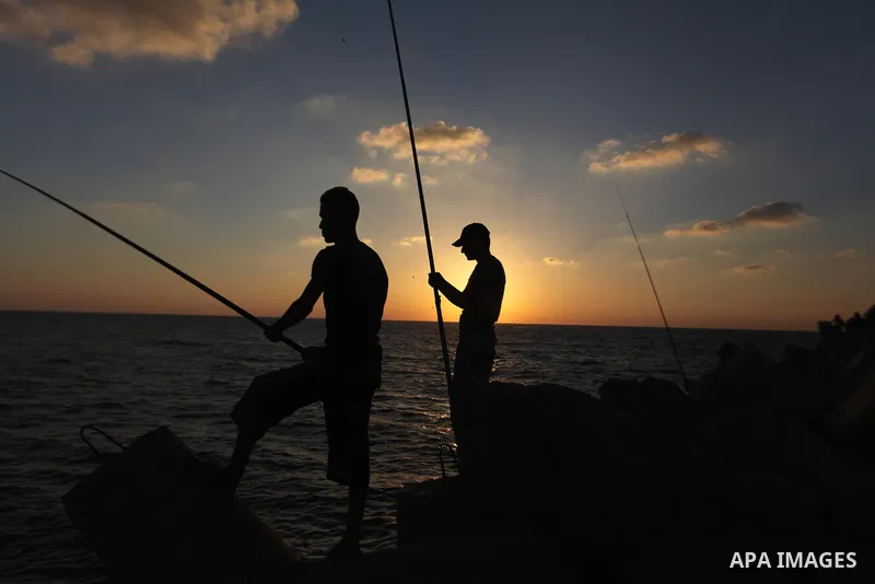 Palestinian fishermen fishing during sunset at Gaza's seaport in Gaza City on Sep. 03 2014. Israel and Hamas accepted an Egyptian proposal for a long-term ceasefire in war-torn Gaza. Restrictions imposed on Gaza fisherme...