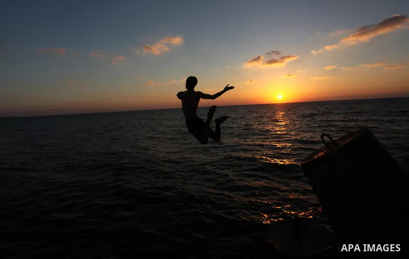 A Palestinian youth jumps into the water in the port in Gaza City on Sep. 03 2014. Israel and Hamas accepted an Egyptian proposal for a long-term ceasefire in war-torn Gaza. Restrictions imposed on Gaza fishermen are to...