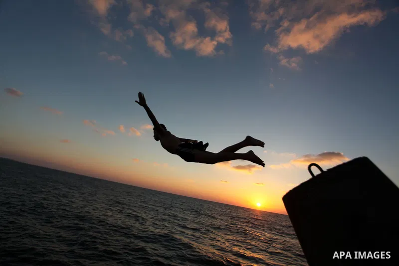 A Palestinian youth jumps into the water in the port in Gaza City on Sep. 03 2014. Israel and Hamas accepted an Egyptian proposal for a long-term ceasefire in war-torn Gaza. Restrictions imposed on Gaza fishermen are to...