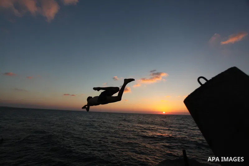 A Palestinian youth jumps into the water in the port in Gaza City on Sep. 03 2014. Israel and Hamas accepted an Egyptian proposal for a long-term ceasefire in war-torn Gaza. Restrictions imposed on Gaza fishermen are to...