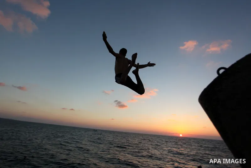 A Palestinian youth jumps into the water in the port in Gaza City on Sep. 03 2014. Israel and Hamas accepted an Egyptian proposal for a long-term ceasefire in war-torn Gaza. Restrictions imposed on Gaza fishermen are to...
