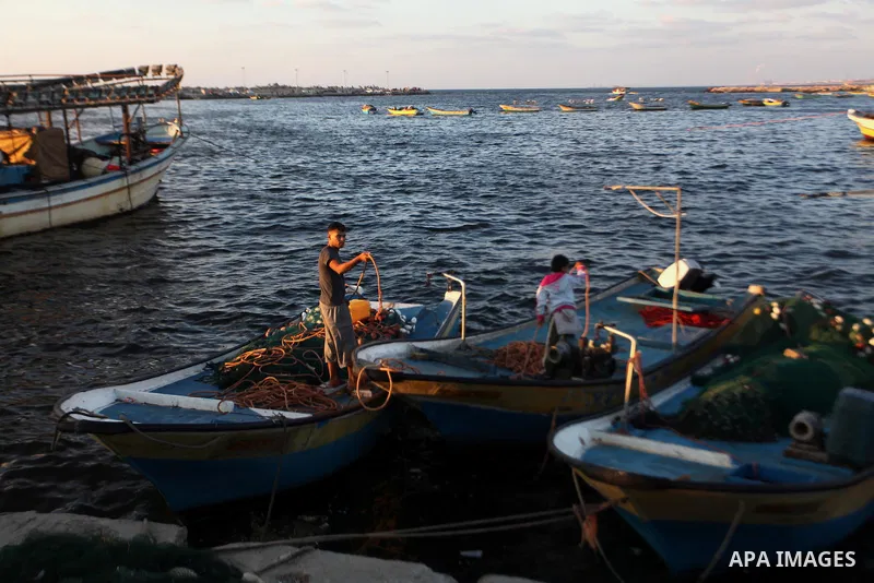 Palestinian fishermen work on their boat at the seaport in Gaza City on Sep. 03 2014. Israel and Hamas accepted an Egyptian proposal for a long-term ceasefire in war-torn Gaza. Restrictions imposed on Gaza fishermen are...