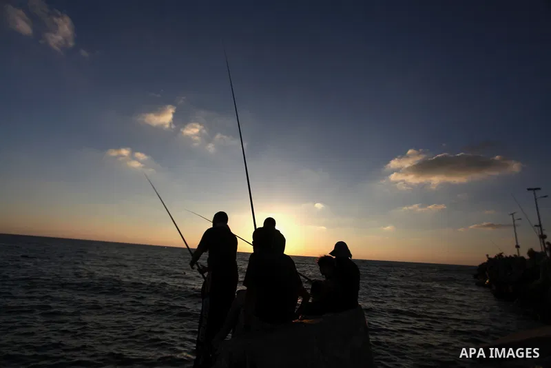 Palestinian fishermen fishing during sunset at Gaza's seaport in Gaza City on Sep. 03 2014. Israel and Hamas accepted an Egyptian proposal for a long-term ceasefire in war-torn Gaza. Restrictions imposed on Gaza fisherme...