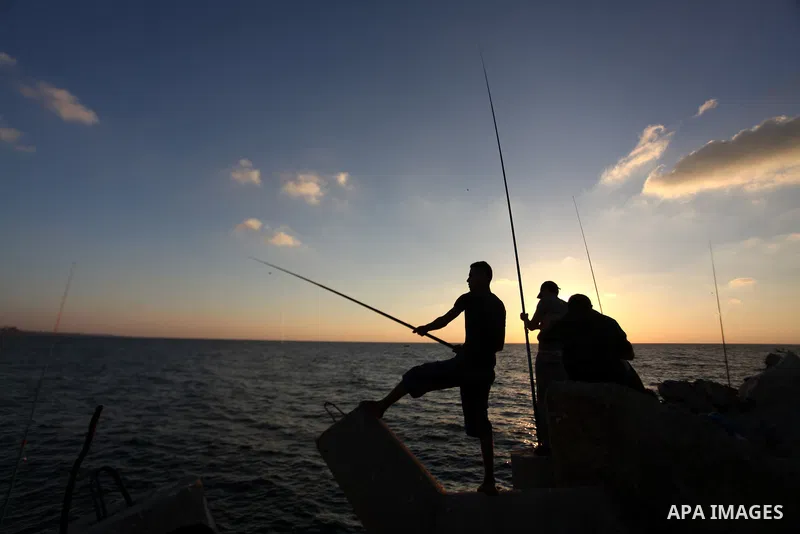 Palestinian fishermen fishing during sunset at Gaza's seaport in Gaza City on Sep. 03 2014. Israel and Hamas accepted an Egyptian proposal for a long-term ceasefire in war-torn Gaza. Restrictions imposed on Gaza fisherme...