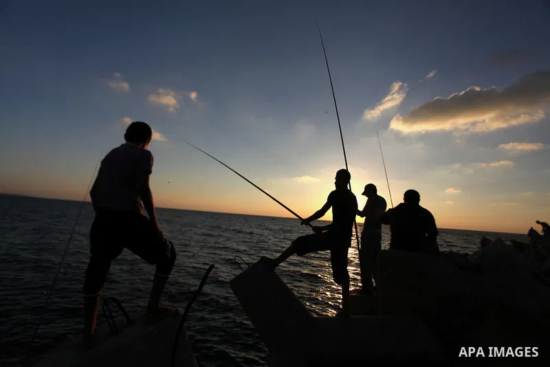 Palestinian fishermen fishing during sunset at Gaza's seaport in Gaza City on Sep. 03 2014. Israel and Hamas accepted an Egyptian proposal for a long-term ceasefire in war-torn Gaza. Restrictions imposed on Gaza fisherme...