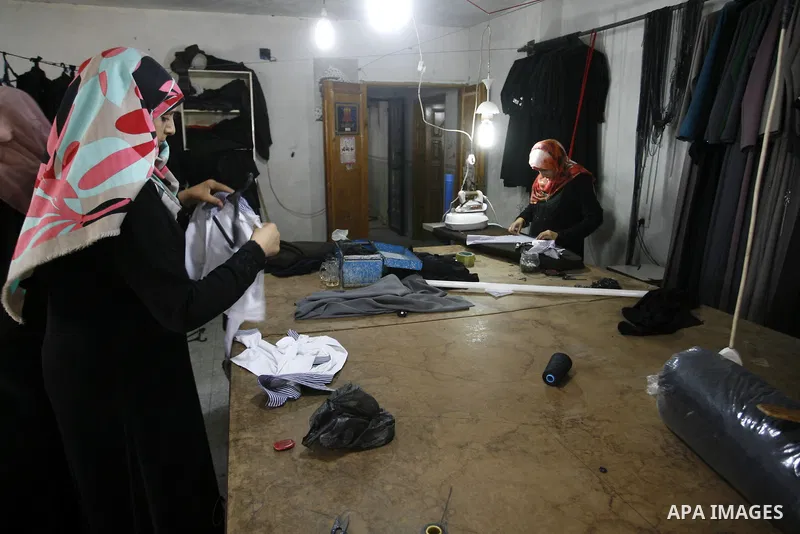 Palestinian tailors sew clothes at a workshop in Rafah in the southern Gaza Strip, on Sep. 04, 2014. Calm returned to the coastal enclave in a August 26 ceasefire, and Gazans were gradually starting to rebuild their live...
