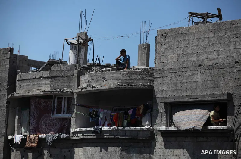Palestinians gather around the the remains of their house that witnesses said were destroyed in an Israeli offensive, after a ceasefire was declared in the Shejaia neighbourhood, east of Gaza City. September 6, 2014. Cal...