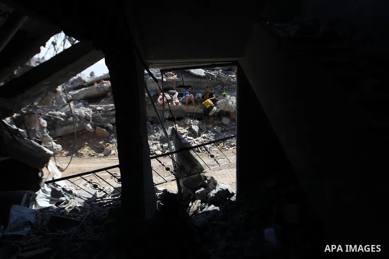 Palestinians gather around the the remains of their house that witnesses said were destroyed in an Israeli offensive, after a ceasefire was declared in the Shejaia neighbourhood, east of Gaza City. September 6, 2014. Cal...