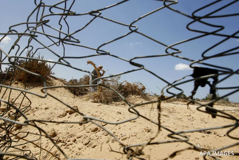 A Palestinian man inspects his farmland which destroyed during fighting between Hamas militants and Israel in east of Rafah in southern Gaza strip on September 07, 2014. Calm returned to the coastal enclave in a August 2...