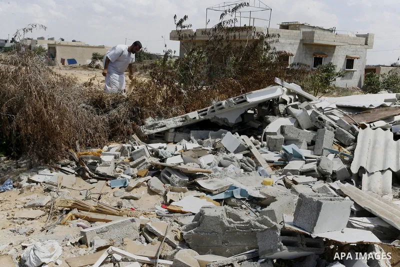 A Palestinian man inspects his farmland which destroyed during fighting between Hamas militants and Israel in east of Rafah in southern Gaza strip on September 07, 2014. Calm returned to the coastal enclave in a August 2...