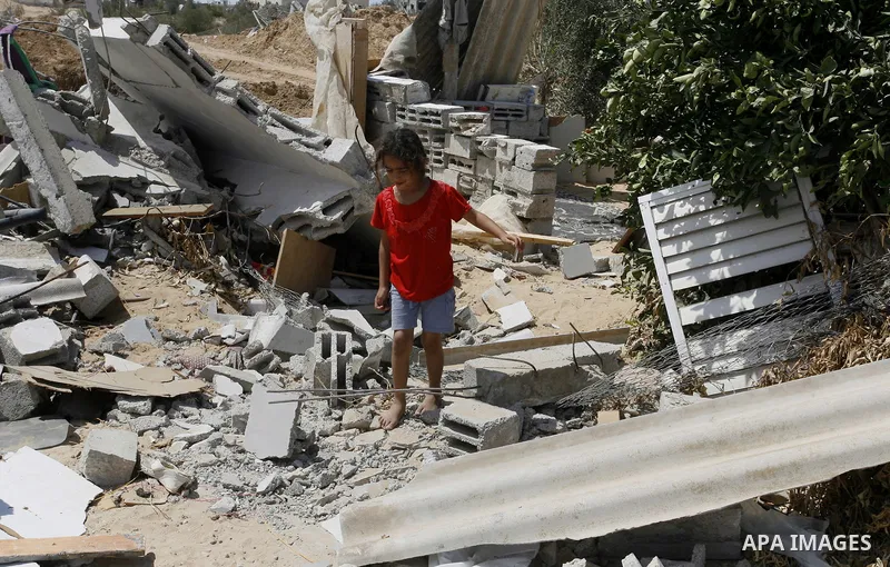 A Palestinian girl walks on the rubble of her famiy's house which destroyed during fighting between Hamas militants and Israel in east of Rafah in southern Gaza strip on September 07, 2014. Calm returned to the coastal e...