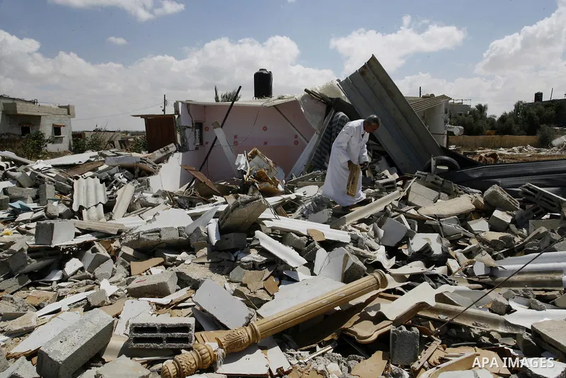 A Palestinian man walks on the rubble of his house which destroyed during fighting between Hamas militants and Israel in east of Rafah in southern Gaza strip on September 07, 2014. Calm returned to the coastal enclave in...