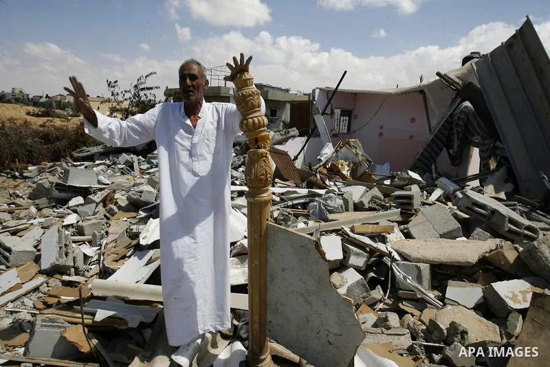 A Palestinian man stands on the rubble of his house which destroyed during fighting between Hamas militants and Israel in east of Rafah in southern Gaza strip on September 07, 2014. Calm returned to the coastal enclave i...