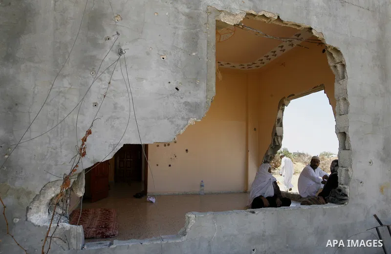Palestinians sit on the rubble of their house which destroyed during fighting between Hamas militants and Israel in east of Rafah in southern Gaza strip on September 07, 2014. Calm returned to the coastal enclave in a Au...