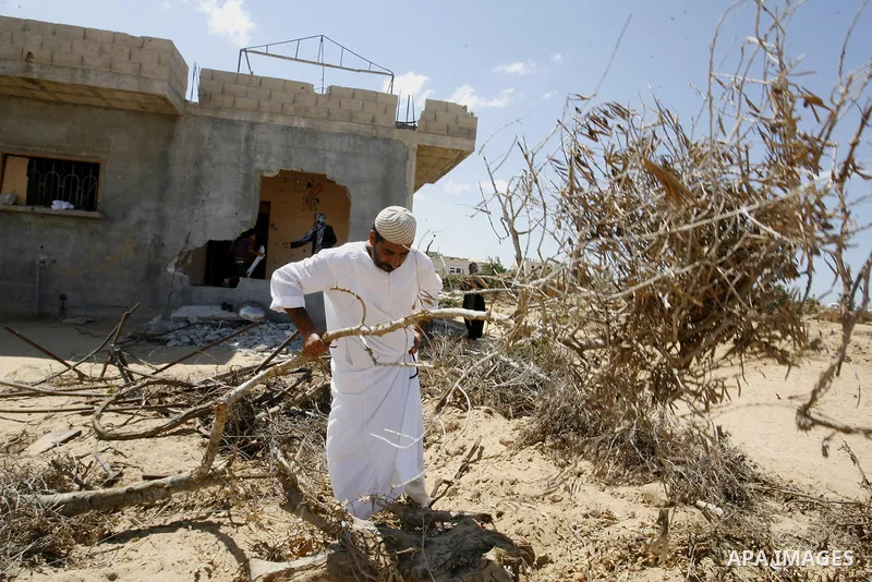 A Palestinian man inspects his farmland which destroyed during fighting between Hamas militants and Israel in east of Rafah in southern Gaza strip on September 07, 2014. Calm returned to the coastal enclave in a August 2...