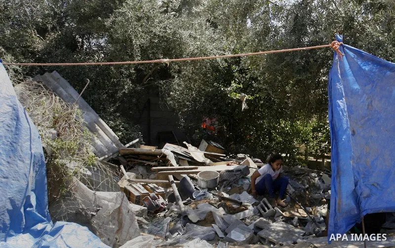 A Palestinian girl sits on the rubble of her famiy's house which destroyed during fighting between Hamas militants and Israel in east of Rafah in southern Gaza strip on September 07, 2014. Calm returned to the coastal en...
