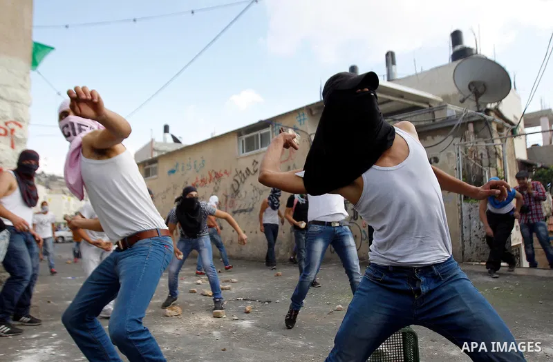 Palestinian protesters hurl stones during clashes with Israeli police in the East Jerusalem neighbourhood of Wadi Joz September 7, 2014. Palestinians rioted in Israeli-occupied East Jerusalem on Sunday after news that a...