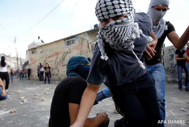 Palestinian protesters hurl stones during clashes with Israeli police in the East Jerusalem neighbourhood of Wadi Joz September 7, 2014. Palestinians rioted in Israeli-occupied East Jerusalem on Sunday after news that a...