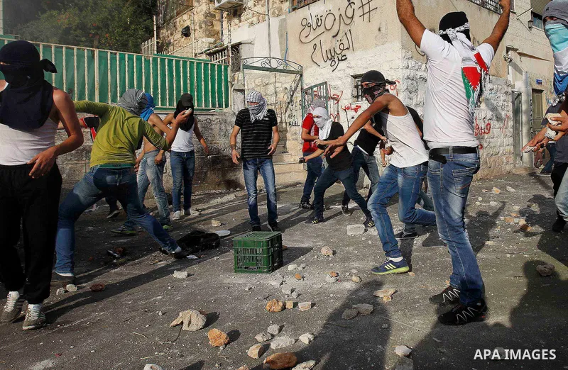 Palestinian protesters hurl stones during clashes with Israeli police in the East Jerusalem neighbourhood of Wadi Joz September 7, 2014. Palestinians rioted in Israeli-occupied East Jerusalem on Sunday after news that a...