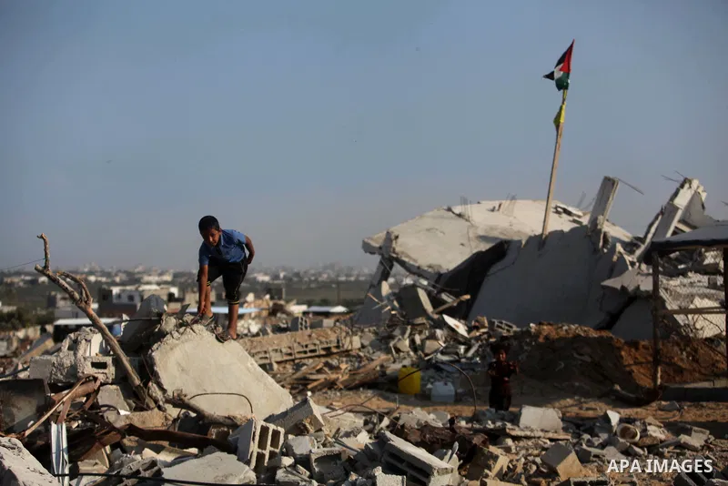 A Palestinian boy walks past the rubble of his house which destroyed during fighting between Hamas militants and Israel in the center of Gaza strip on September 08, 2014. Calm returned to the coastal enclave in a August...
